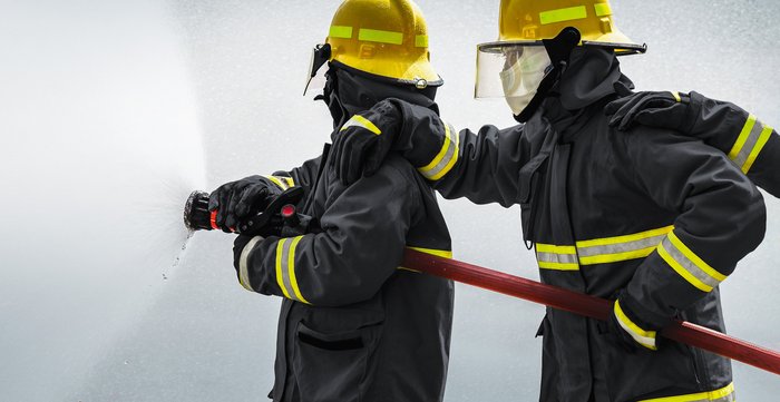 Firefighter at work - wearing fireresistant clothes made from high performance fibers