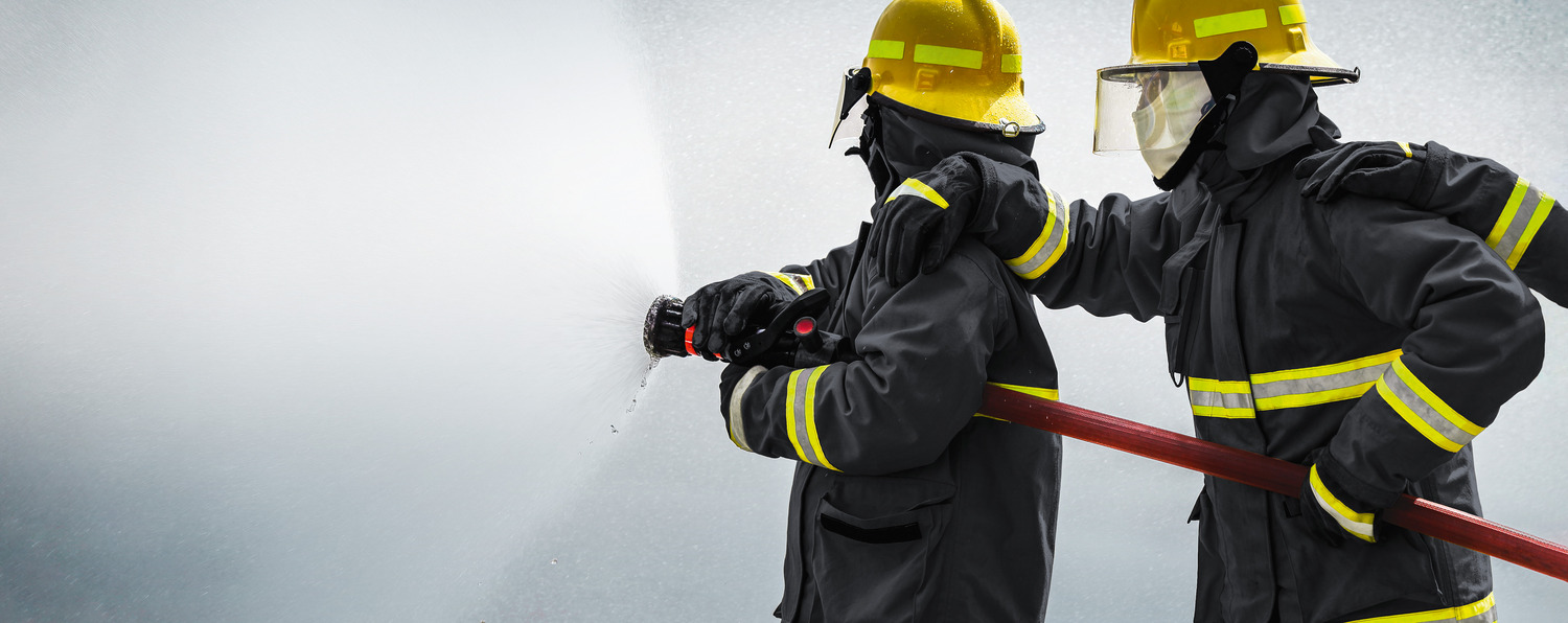 Firefighter at work - wearing fireresisting clothes made form high performance fibers