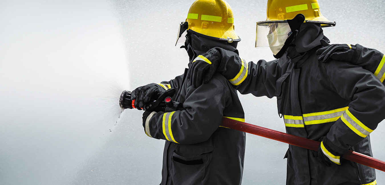 Firefighter ast work - wearing fireresistant clothes made from high performance fibers